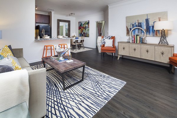 Spacious living room with modern decor and large windows at Avana Portico Apartments, providing a comfortable and elegant living space