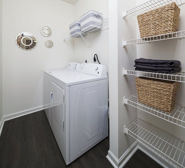 Modern laundry room with energy-efficient washers and dryers at Avana Portico Apartments