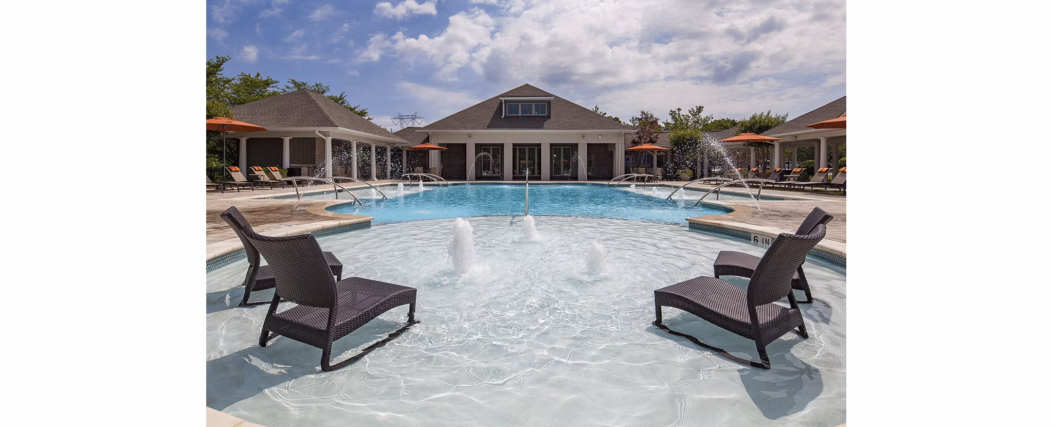 Luxury poolside lounge at Avana Portico Apartments with resort-style seating and ambient lighting