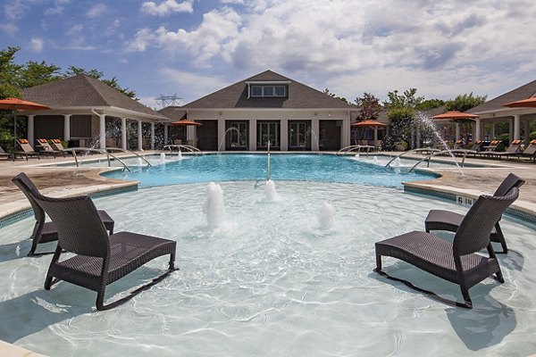 Luxury poolside lounge at Avana Portico Apartments with resort-style seating and ambient lighting
