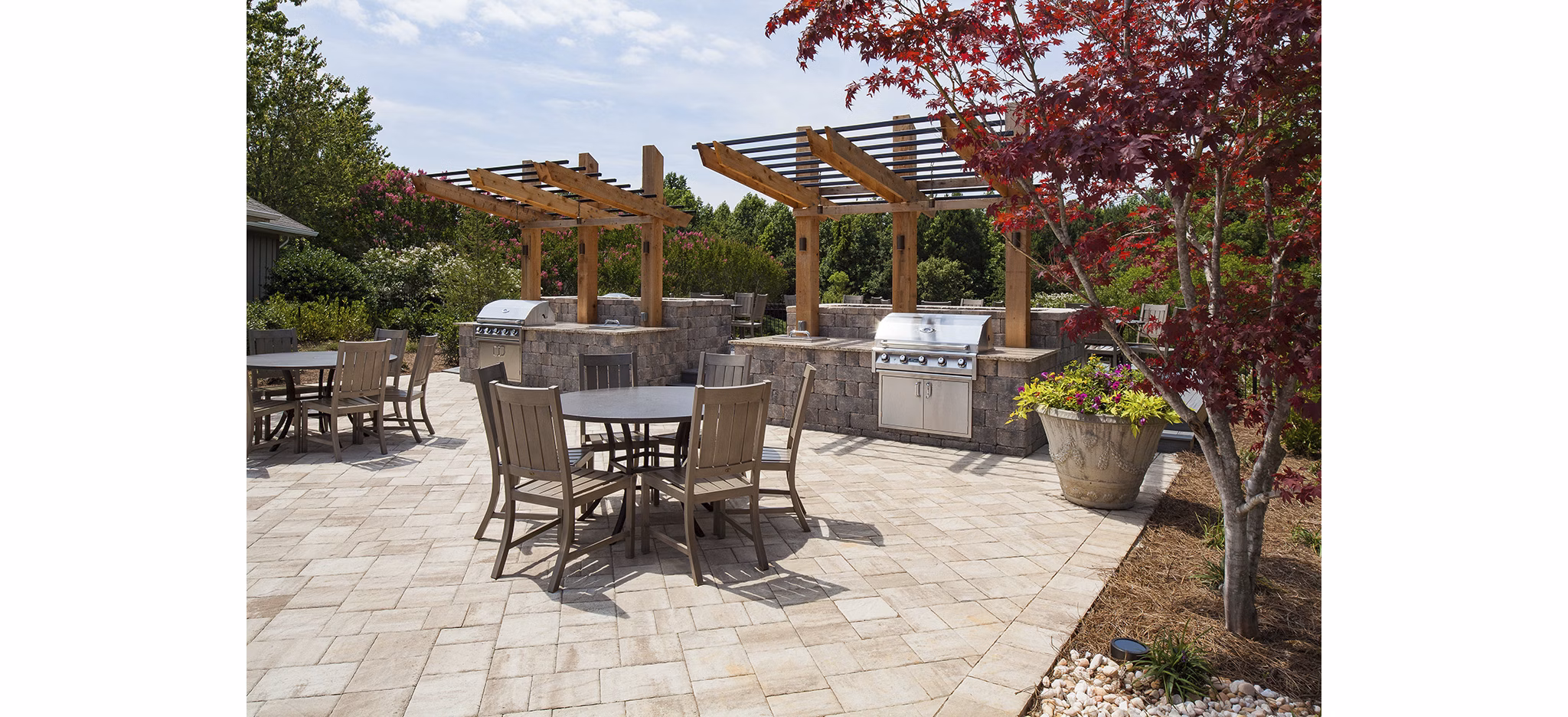 Outdoor barbecue grills in the modern entertainment area at Avana Portico Apartments, perfect for hosting gatherings and enjoying luxury amenities