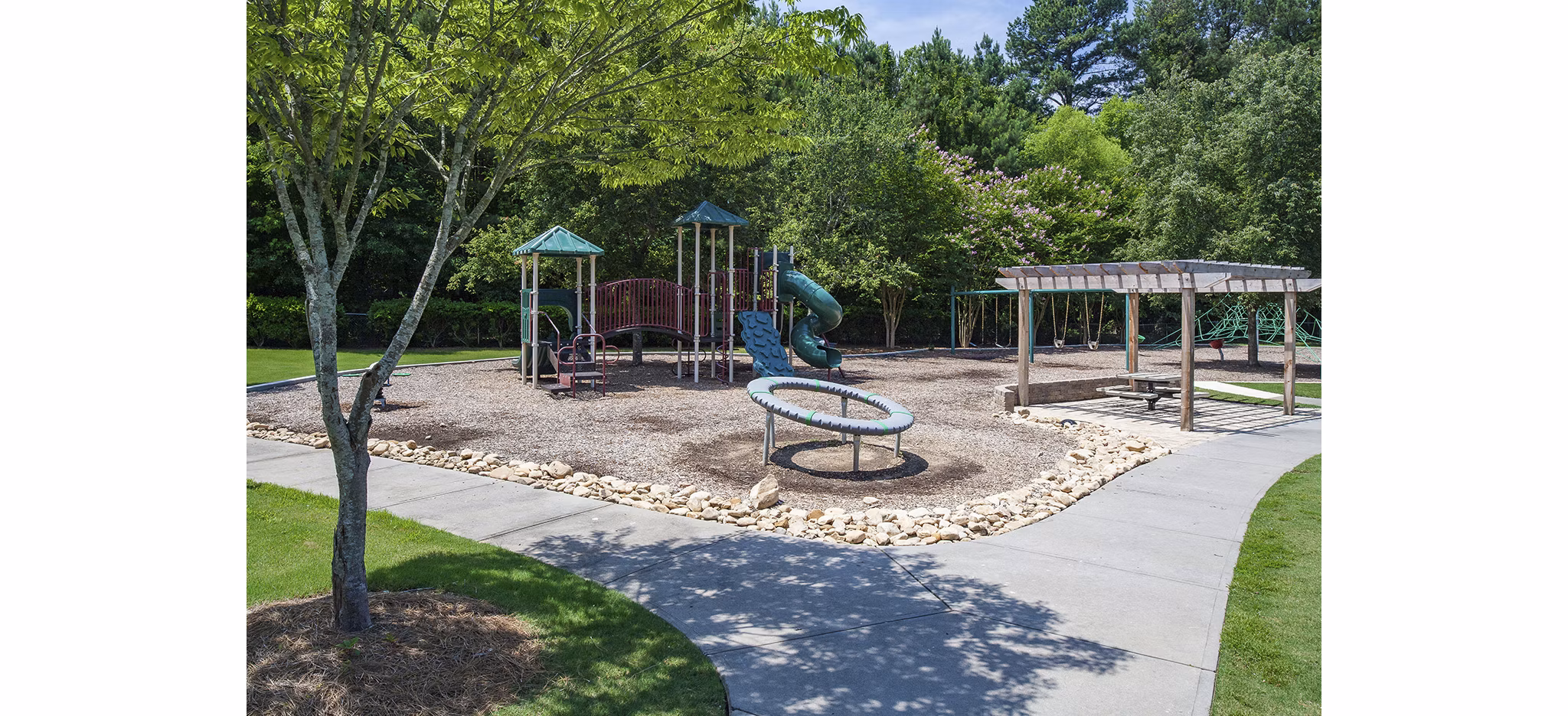 Modern playground with vibrant equipment at Avana Portico Apartments, offering luxury family-friendly amenities