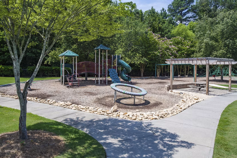 Modern playground with vibrant equipment at Avana Portico Apartments, offering luxury family-friendly amenities