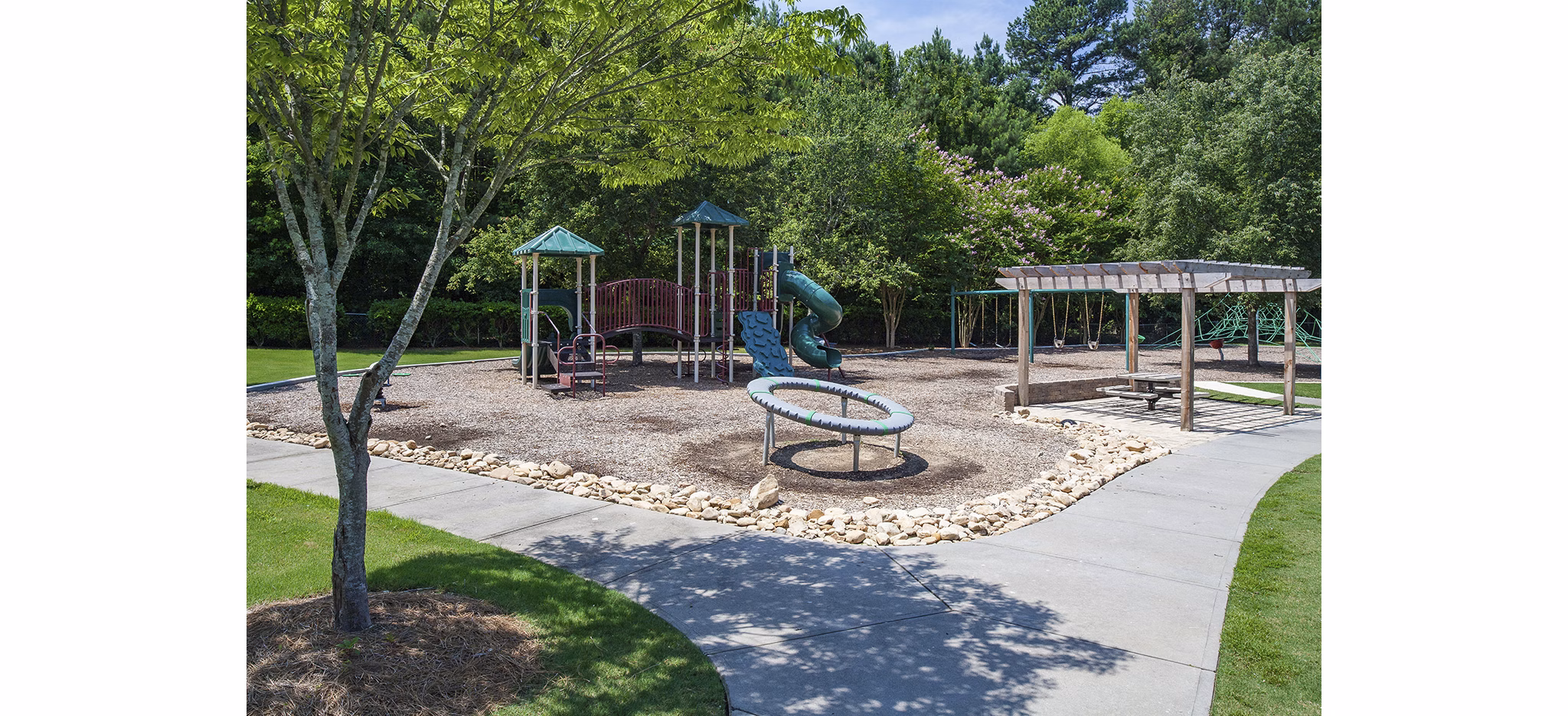 Modern playground with vibrant equipment at Avana Portico Apartments, offering luxury family-friendly amenities