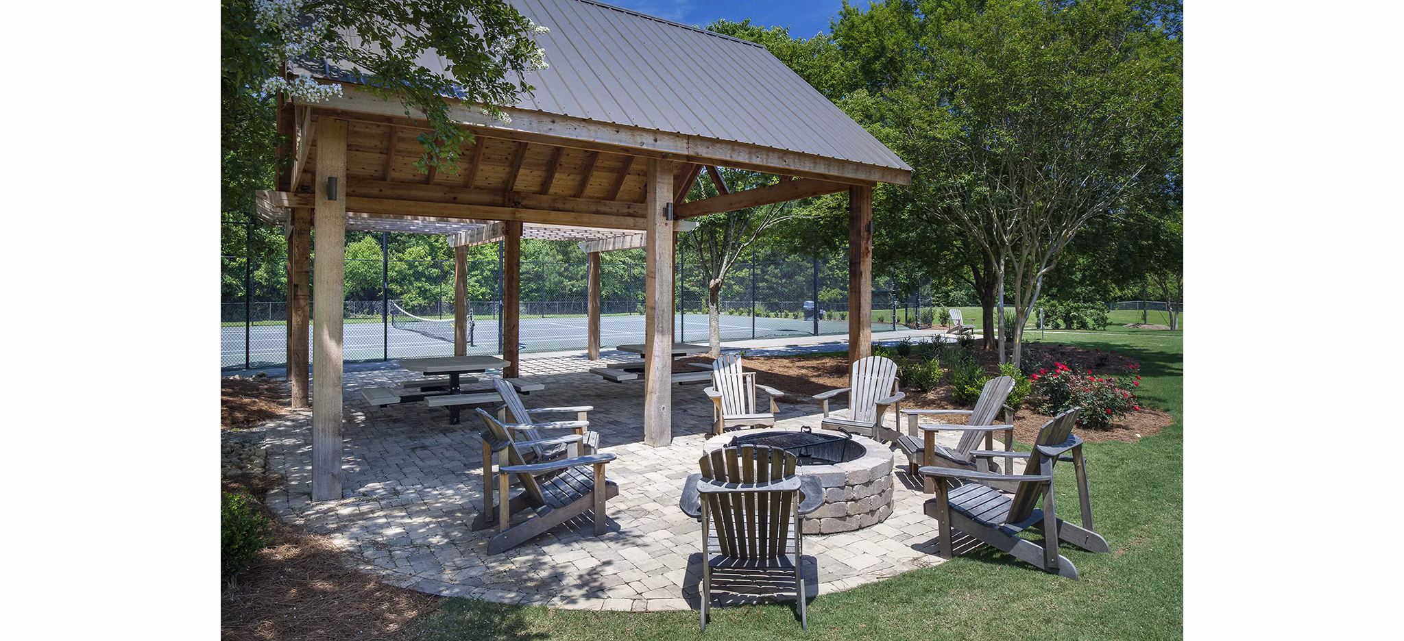 Modern fire pit seating area at Avana Portico Apartments offering cozy outdoor entertainment space