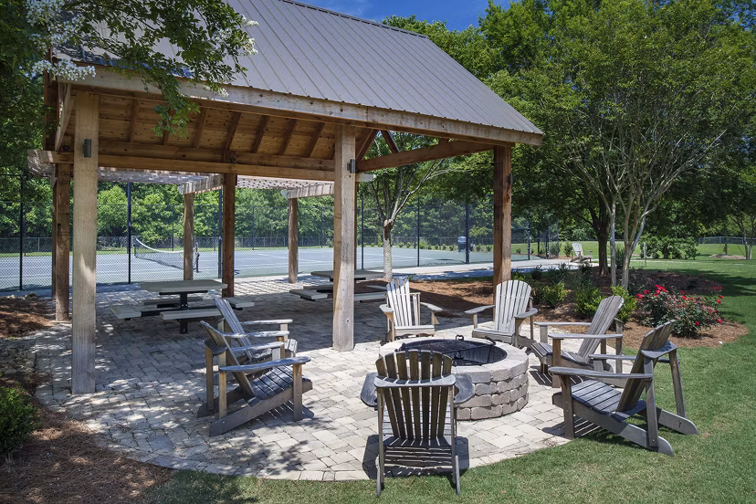 Modern fire pit seating area at Avana Portico Apartments offering cozy outdoor entertainment space