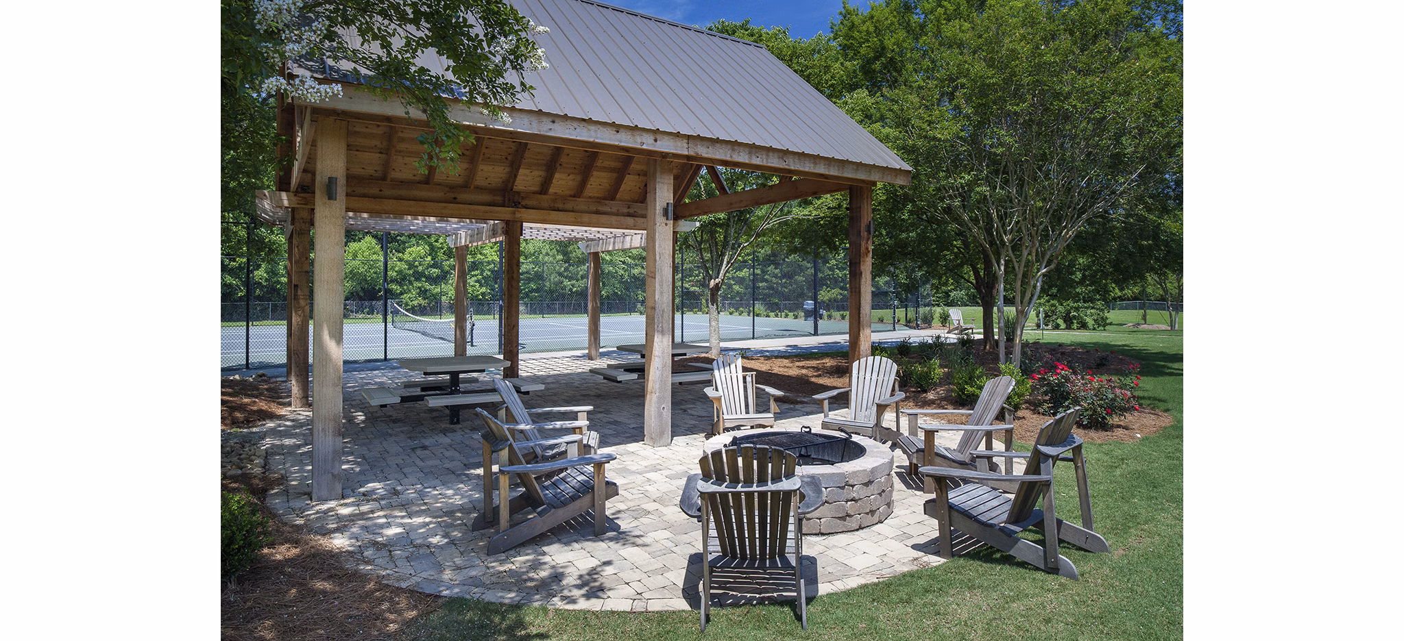 Modern fire pit seating area at Avana Portico Apartments offering cozy outdoor entertainment space