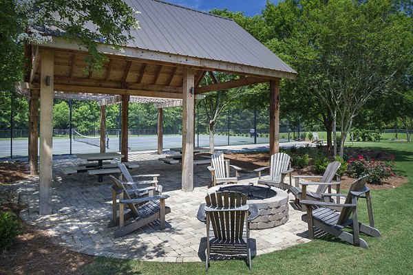 Modern fire pit seating area at Avana Portico Apartments offering cozy outdoor entertainment space