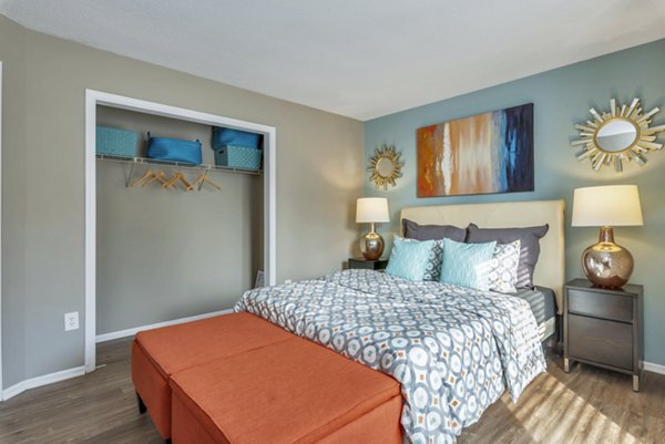 Stylish bedroom with modern decor and large window at Avana Matthews Apartments