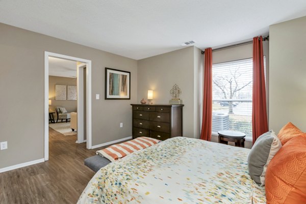 Cozy bedroom with modern decor at Avana Matthews Apartments, featuring luxury amenities for a comfortable living experience