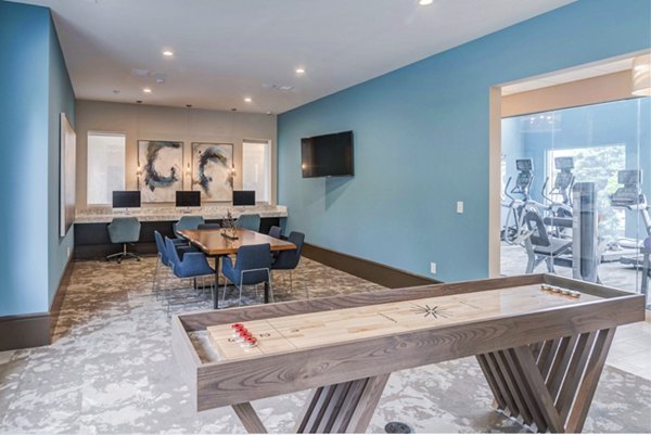 Business center and game room featuring modern workstations and pool table at Avana Matthews Apartments