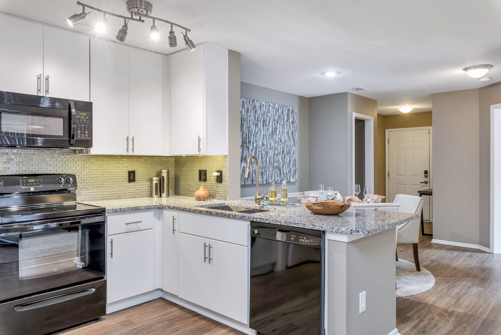 Modern kitchen with stainless steel appliances and granite countertops at Avana Matthews Apartments