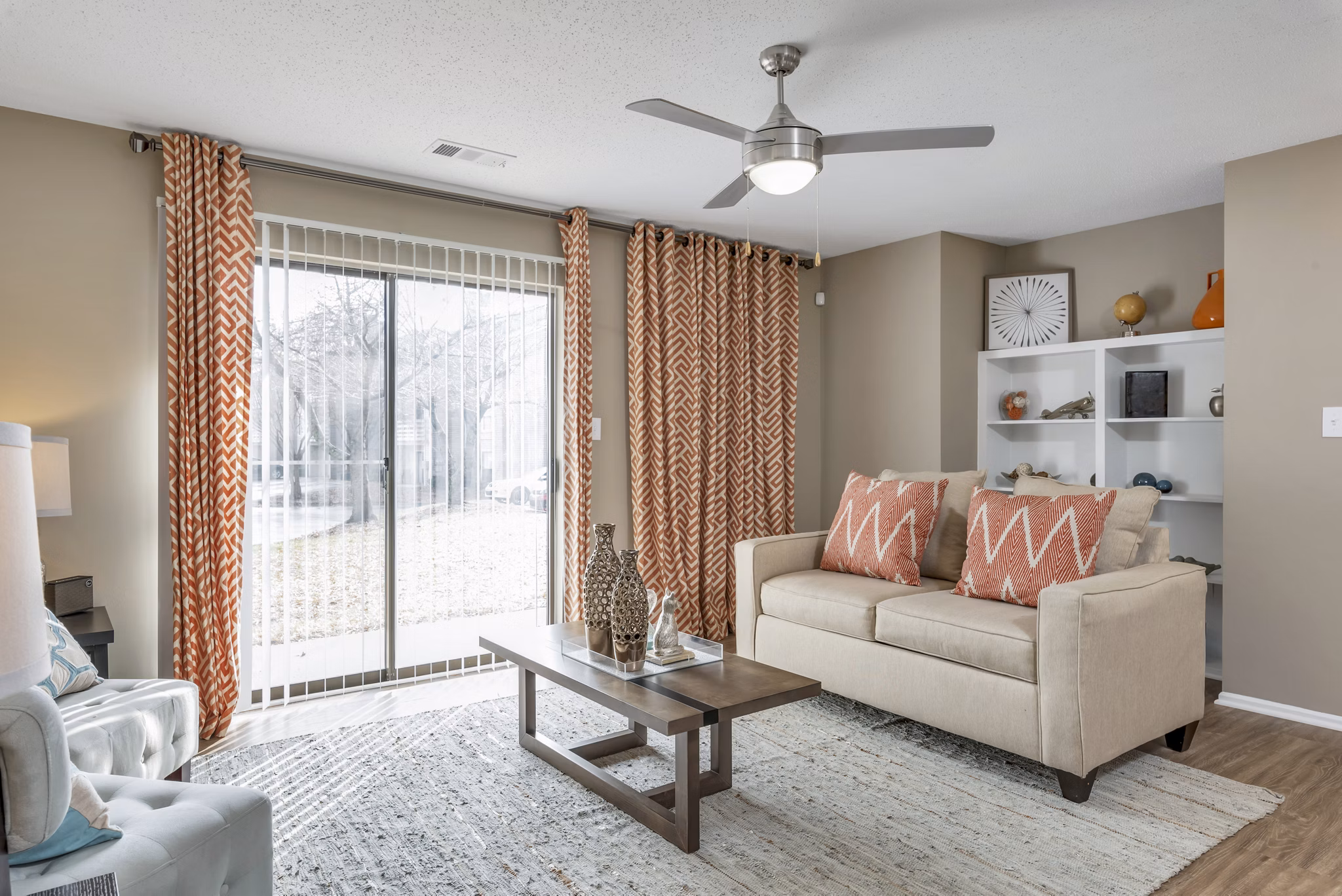 Living area with modern decor and large windows at Avana Matthews Apartments