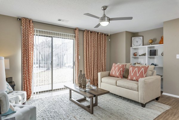 Living area with modern decor and large windows at Avana Matthews Apartments