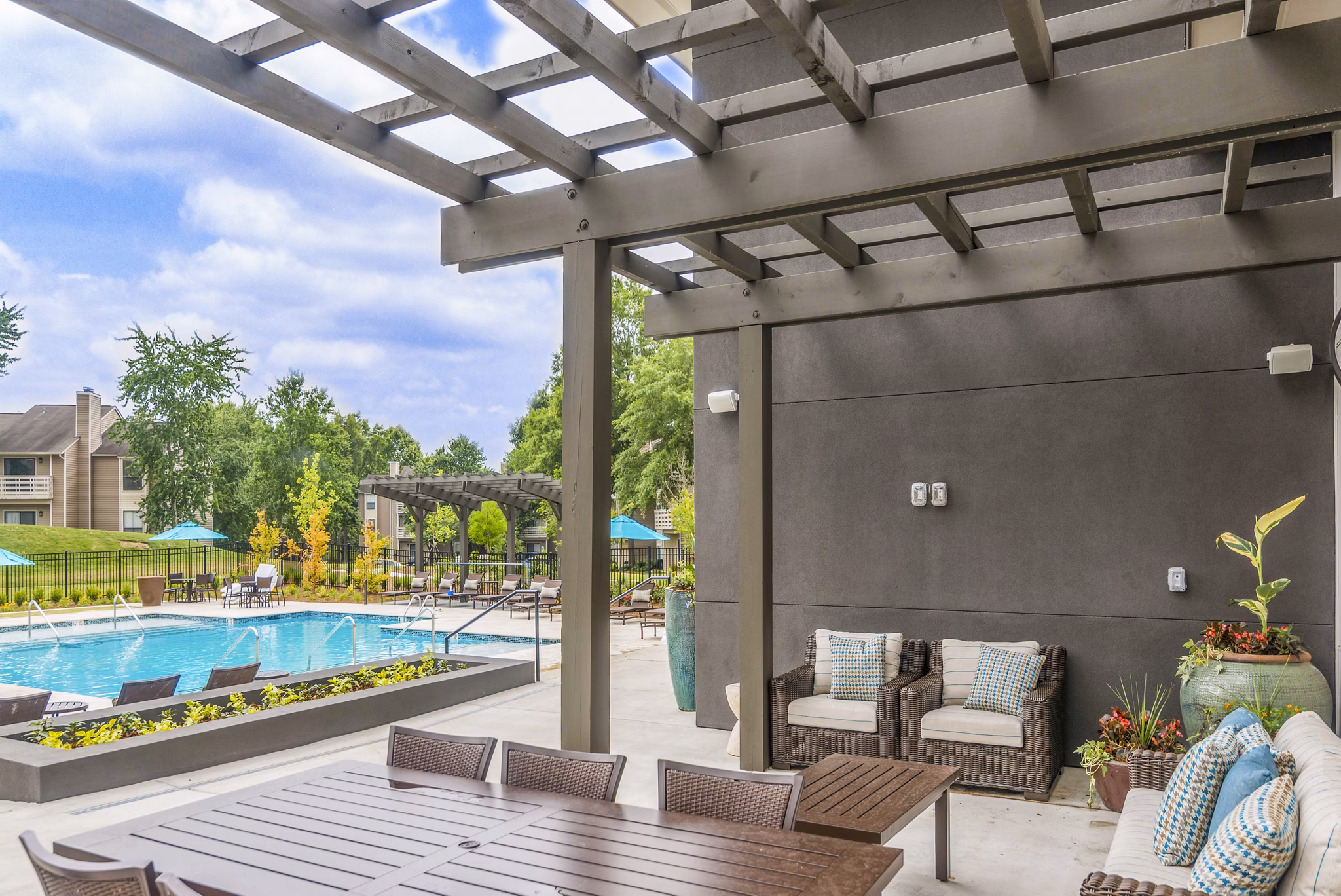 Patio with cozy seating and garden view at Avana Matthews Apartments