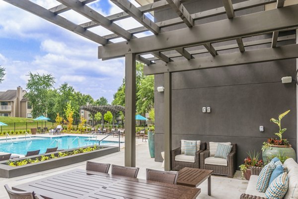 Patio with cozy seating and garden view at Avana Matthews Apartments