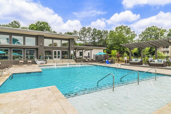 Resort-style pool with sun loungers at Avana Matthews Apartments