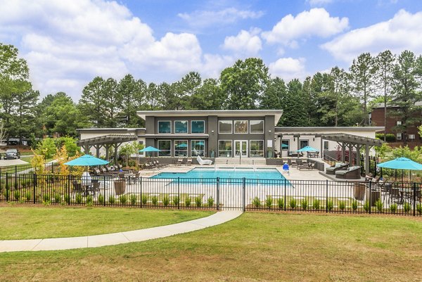 Sparkling pool with lounge chairs at Avana Matthews Apartments in Matthews, North Carolina