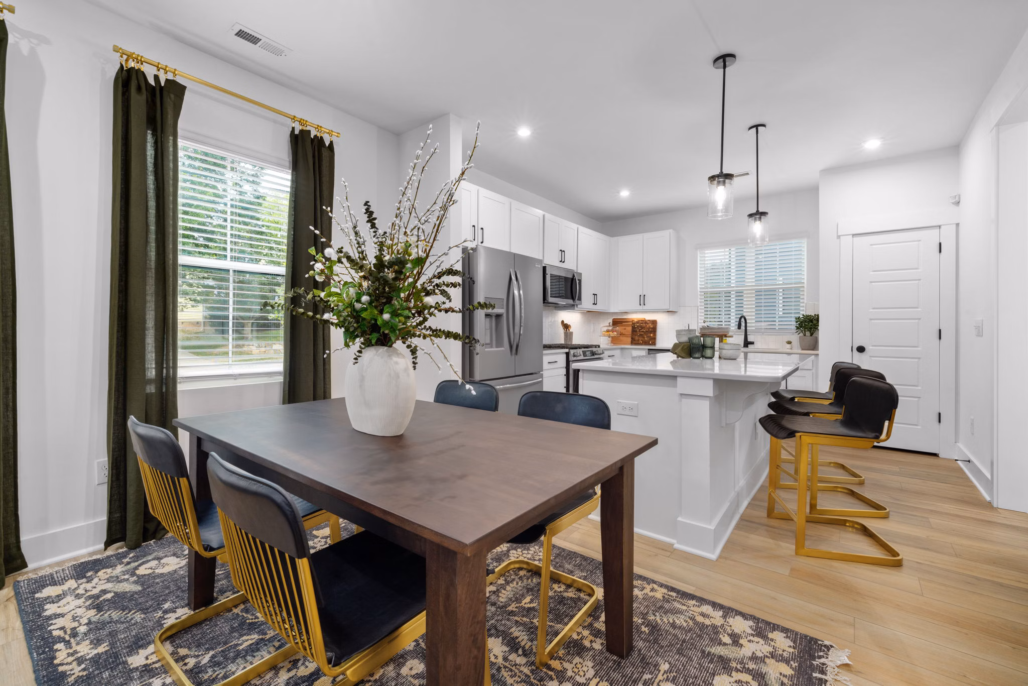 Dining area featuring modern decor and high ceilings in ABODE at Hargett Apartments