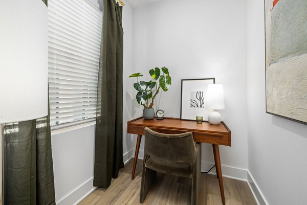 Home office with modern desk and ergonomic chair at ABODE at Hargett Apartments