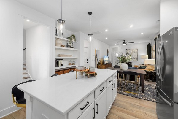 Modern kitchen with stainless steel appliances in ABODE at Hargett Apartments