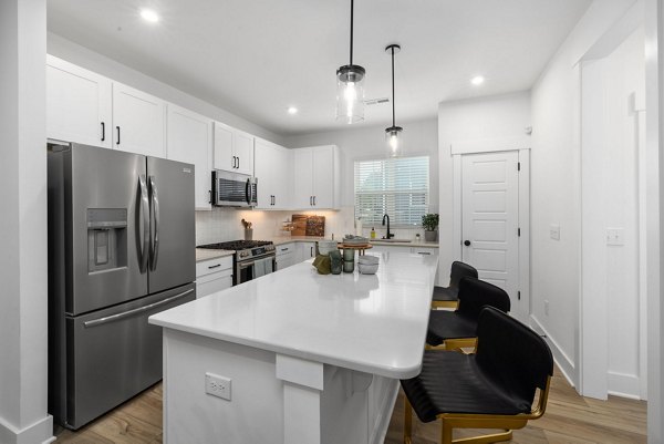 Kitchen with stainless steel appliances in ABODE at Hargett Apartments
