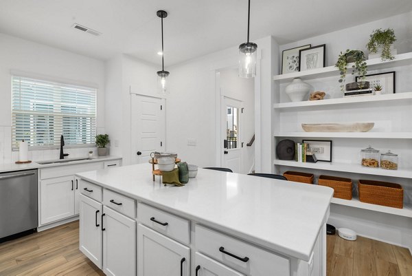 Modern kitchen with stainless steel appliances at ABODE at Hargett Apartments, offering luxury living with premium amenities in a vibrant community