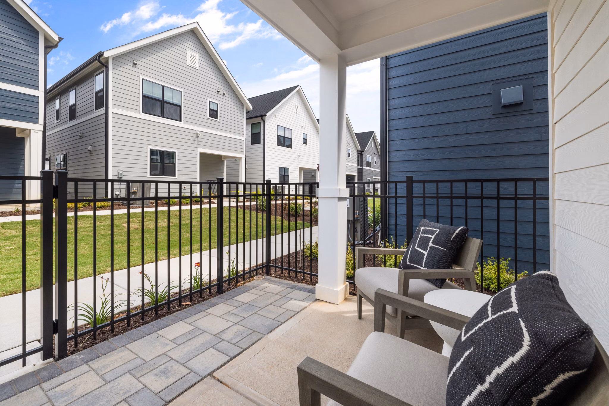 Modern patio with outdoor seating at ABODE at Hargett Apartments, perfect for relaxation and entertaining in a vibrant community setting