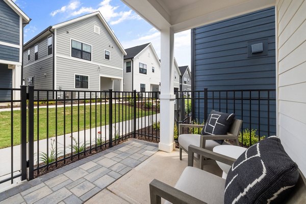 Modern patio with outdoor seating at ABODE at Hargett Apartments, perfect for relaxation and entertaining in a vibrant community setting