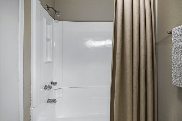 Modern bathroom with marble countertops and sleek fixtures at Coronado Palms Apartments, offering luxury living near the beach