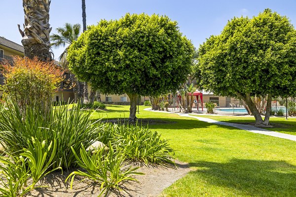 Coronado Palms Apartments: Tranquil courtyard with lush landscaping and seating areas