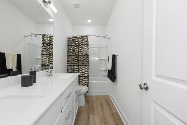 Elegant modern bathroom featuring marble countertops and sleek fixtures at Oak Lake Townhomes Apartments, a Greystar luxury property