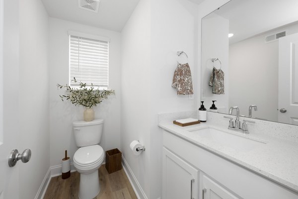 Oak Lake Townhomes: Modern bathroom with sleek fixtures and large mirror in luxury apartment