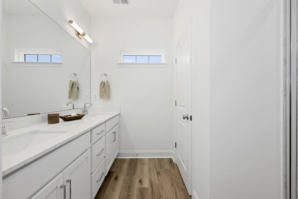Bathroom featuring elegant vanity and modern fixtures at Oak Lake Townhomes Apartments