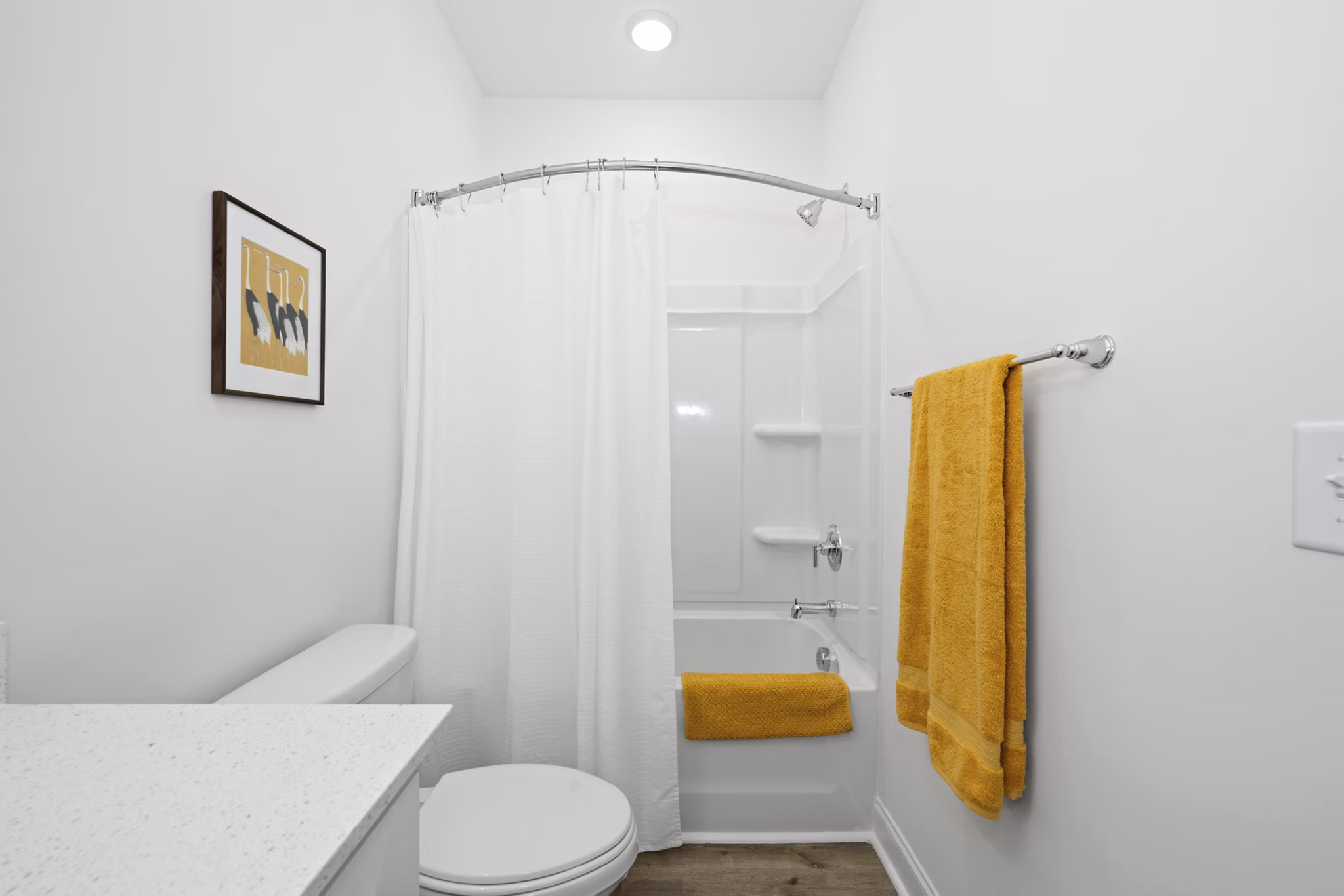 Modern bathroom with sleek fixtures and ample lighting in Oak Lake Townhomes Apartments