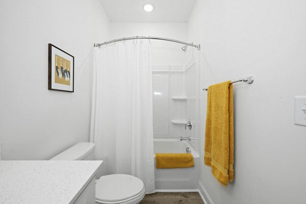 Modern bathroom with sleek fixtures and ample lighting in Oak Lake Townhomes Apartments