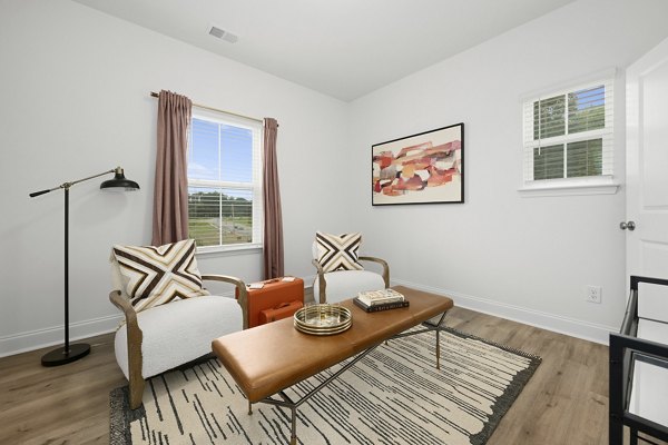 Clubhouse at Oak Lake Townhomes Apartments featuring modern design and cozy seating, ideal for community gatherings
