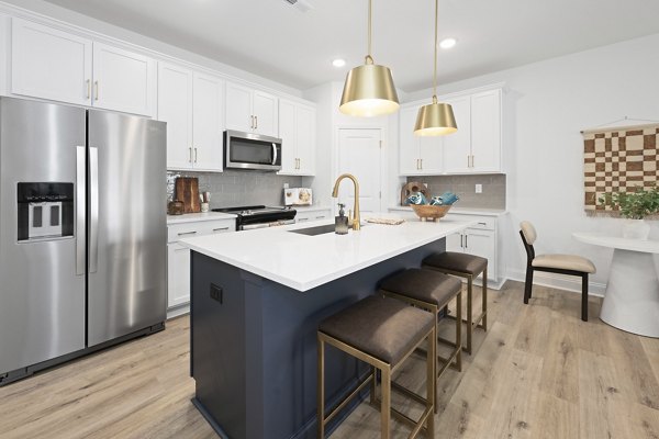 Dining room featuring modern furnishings and natural light in Oak Lake Townhomes Apartments