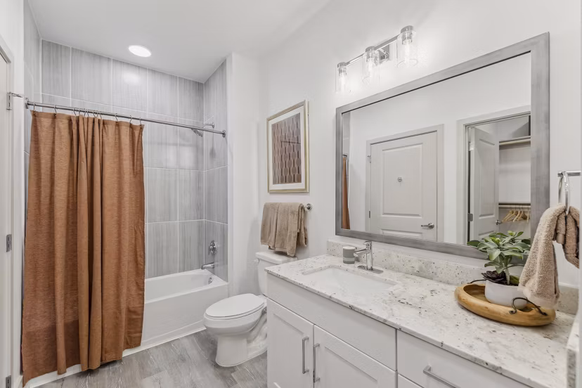 Modern bathroom with sleek fixtures and marble countertops at Alta Grandway Apartments