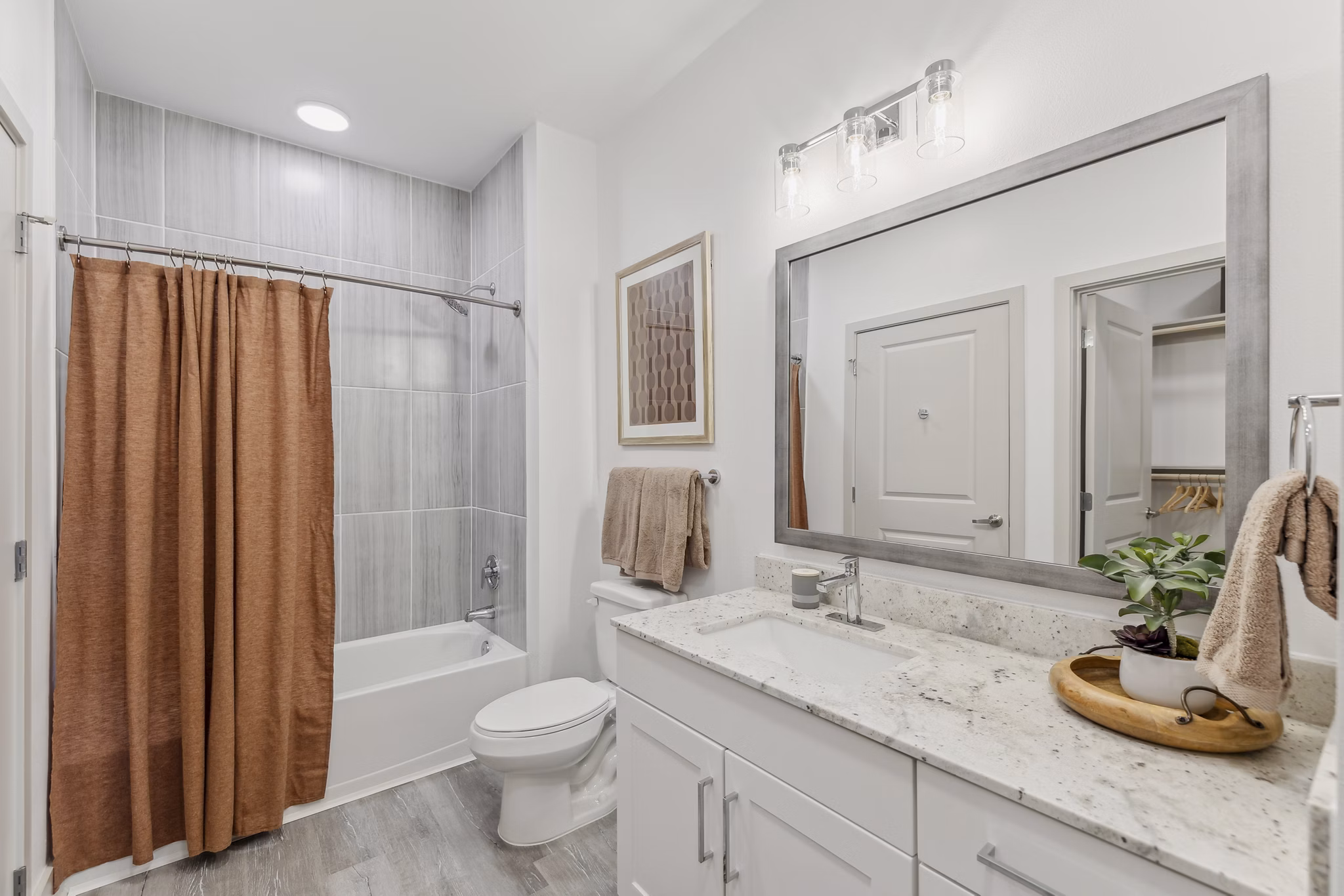 Modern bathroom with sleek fixtures and marble countertops at Alta Grandway Apartments