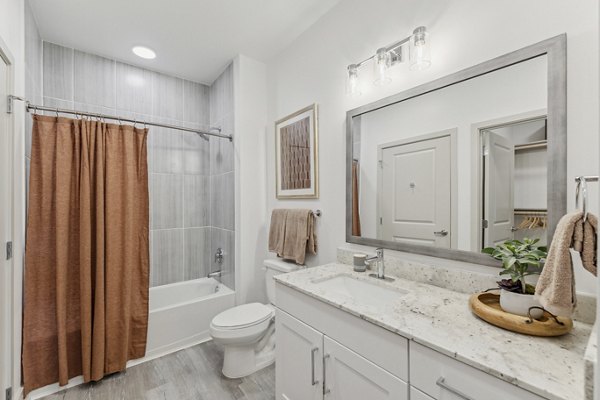 Modern bathroom with sleek fixtures and marble countertops at Alta Grandway Apartments