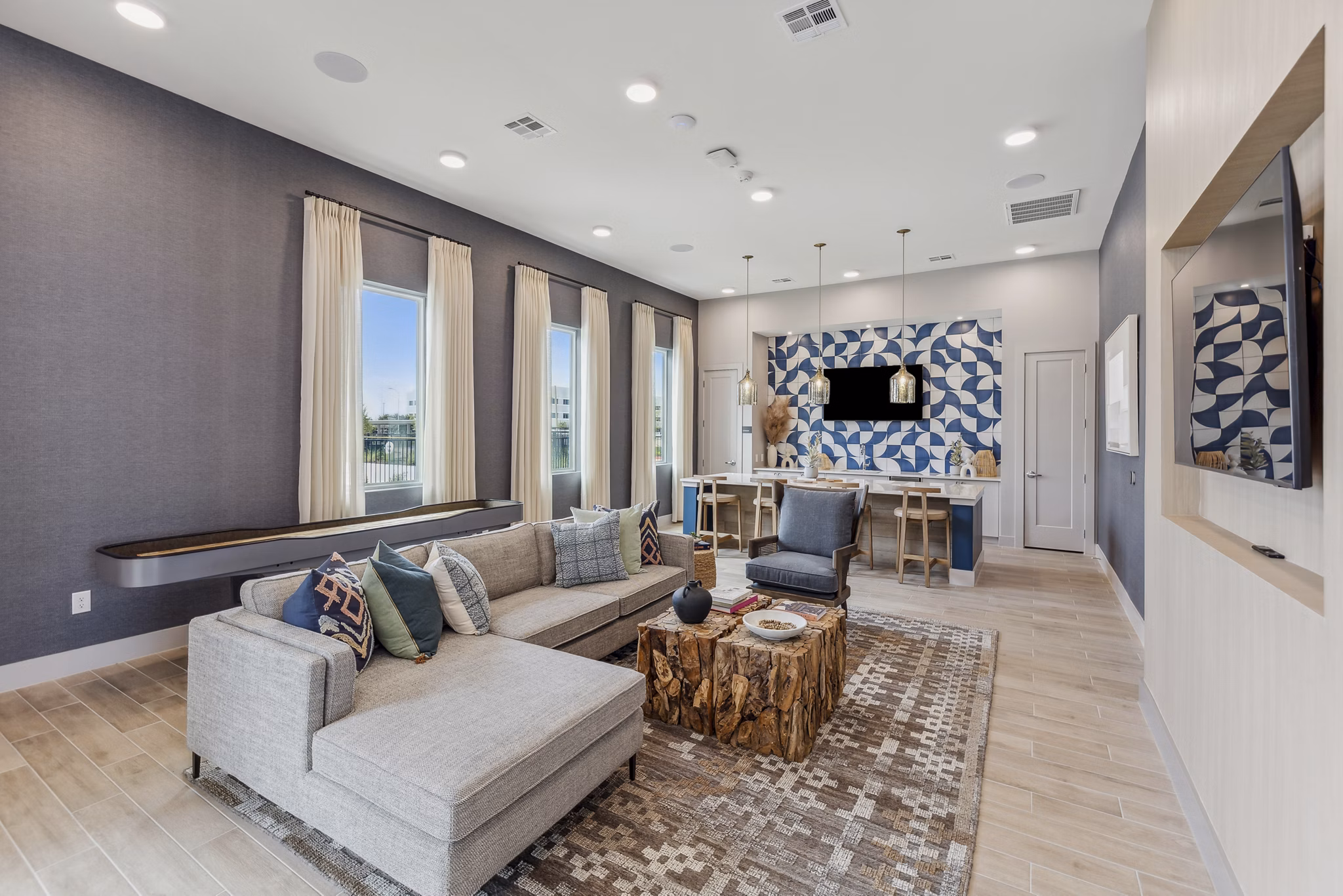 Clubhouse featuring modern design and ample seating at Alta Grandway Apartments