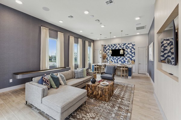 Clubhouse featuring modern design and ample seating at Alta Grandway Apartments