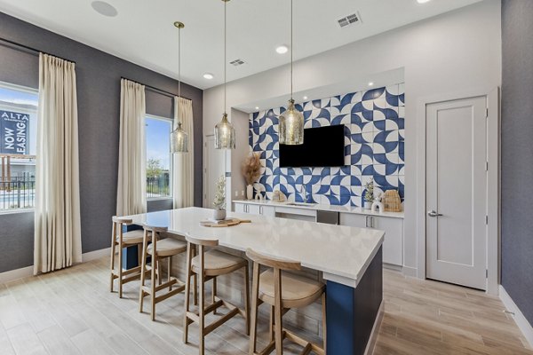 Modern clubhouse with elegant seating and large TV at Alta Grandway Apartments
