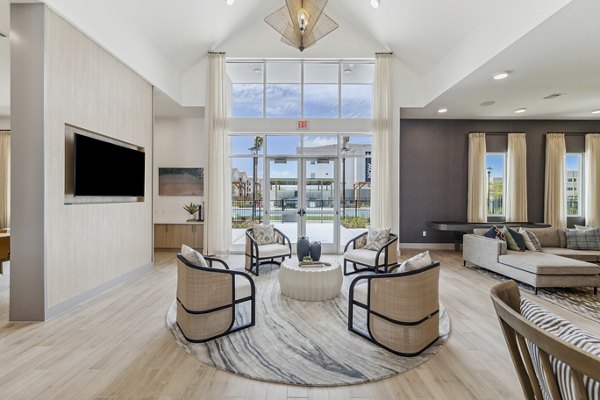 Modern clubhouse featuring spacious seating and pool table at Alta Grandway Apartments Ideal for social gatherings and relaxation