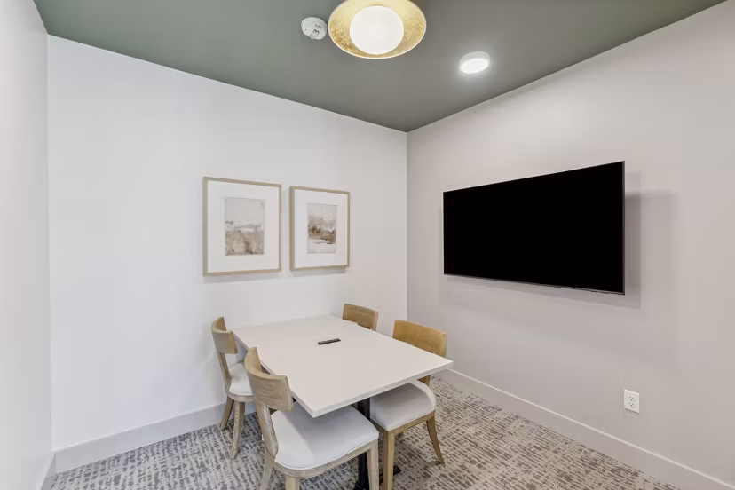 Modern meeting facility with spacious seating and advanced AV setup at Alta Grandway Apartments