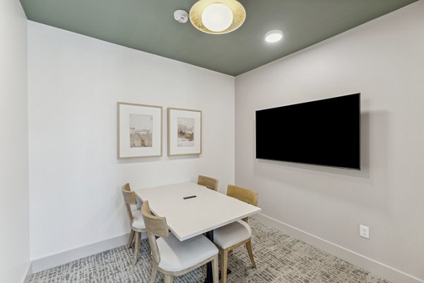 Modern meeting facility with spacious seating and advanced AV setup at Alta Grandway Apartments