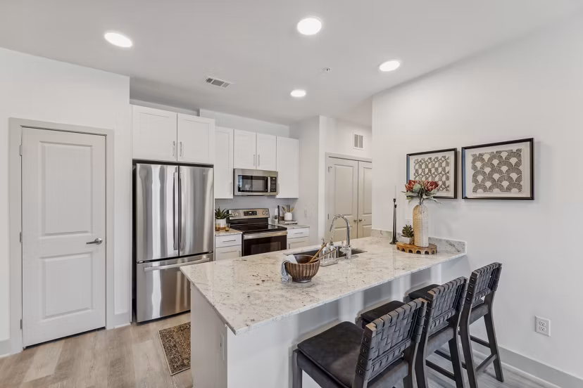 Modern kitchen with sleek countertops and stainless steel appliances in Alta Grandway Apartments