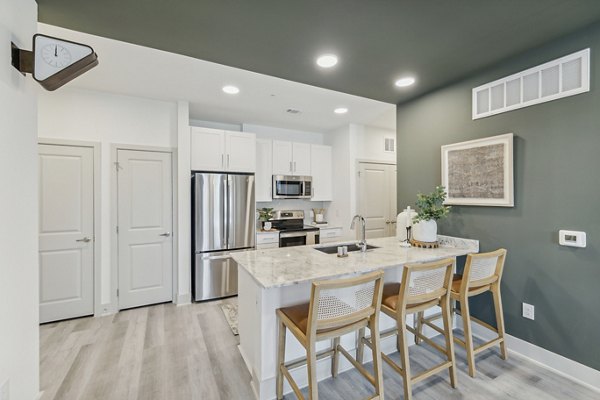 Modern kitchen with stainless steel appliances in Alta Grandway Apartments, luxury living by Greystar