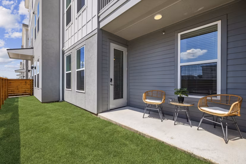 Rooftop patio with modern seating at Alta Grandway Apartments, offering luxury outdoor living space in a serene setting